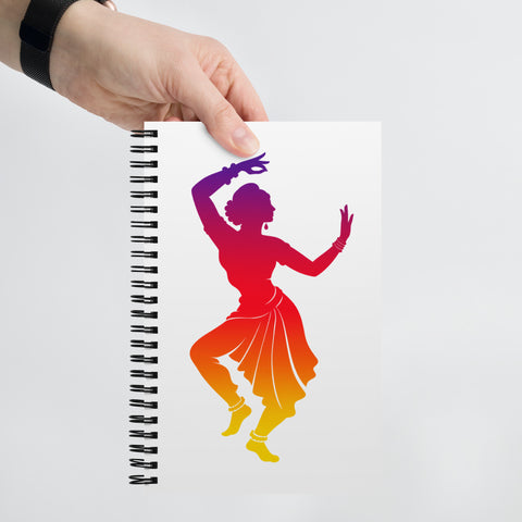 White spiral notebook with a centred classical dancer silhouette in purple, magenta, red, orange and yellow on the front – ZIPZAPPA