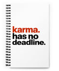 White spiral notebook with rust-orange and black Karma Has No Deadline lettering centred on the front cover – ZIPZAPPA