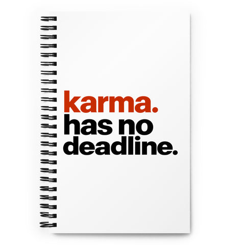 White spiral notebook with rust-orange and black Karma Has No Deadline lettering centred on the front cover – ZIPZAPPA