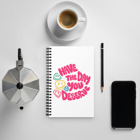 White spiral notebook with original pink Have the Day You Deserve lettering and colourful smiley faces centred on the front – ZIPZAPPA