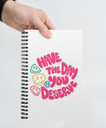 White spiral notebook with original pink Have the Day You Deserve lettering and colourful smiley faces centred on the front – ZIPZAPPA