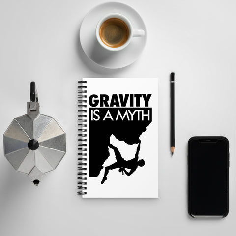 Original Gravity Is a Myth climber emblem on the front of a dotted spiral notebook – mockup 3 – ZIPZAPPA
