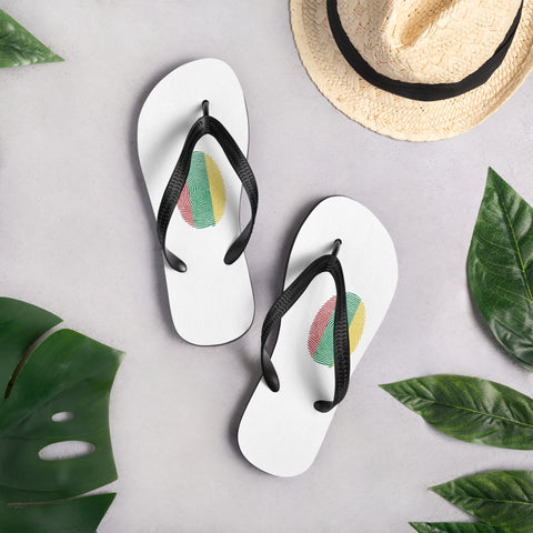 Lithuanian Fingerprint white flip-flops with red green and yellow prints and black straps – lifestyle view 2