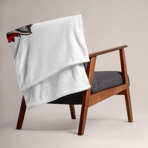 Fire Wolf throw blanket draped over a wooden armchair showing its plain white reverse side.