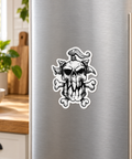 Black-and-white Viking Skull die-cut magnet on a stainless steel fridge door in a sunlit kitchen.