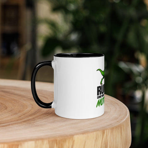 Left-side view of the 11 oz Dinosaur Motivation ceramic mug with black interior and handle on a round wooden table with softly blurred greenery, showing its single front design.