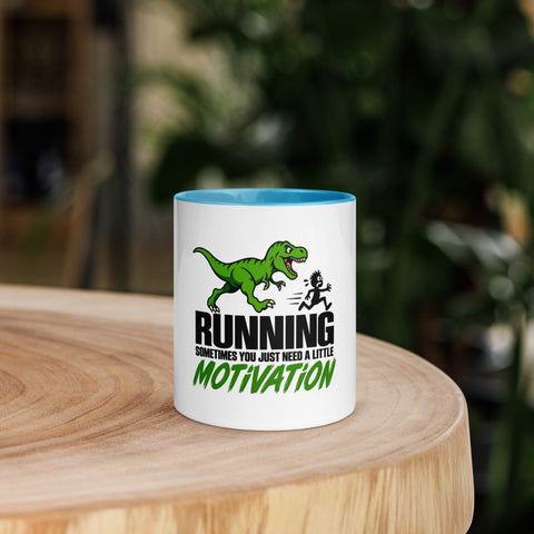 Front view of the 11 oz Dinosaur Motivation ceramic mug with blue interior and handle on a round wooden table with softly blurred greenery, showing its single front design.