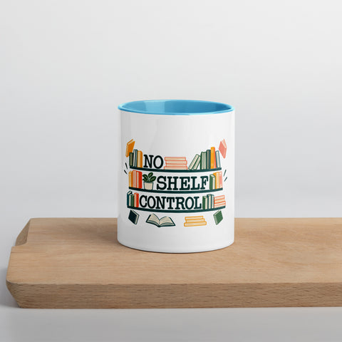 11 oz white No Shelf Control ceramic mug with blue interior, rim and handle, front view on a wooden board; book illustration and green lettering printed once on the front.