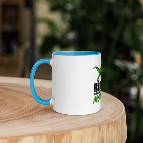Left-side view of the 11 oz Dinosaur Motivation ceramic mug with blue interior and handle on a round wooden table with softly blurred greenery, showing its single front design.