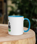 Right-side view of the 11 oz Dinosaur Motivation ceramic mug with blue interior and handle on a round wooden table with softly blurred greenery, showing its single front design.