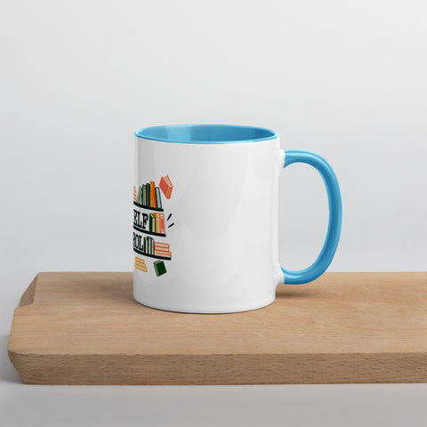 11 oz white No Shelf Control ceramic mug with blue interior, rim and handle, right view on a wooden board; book illustration and green lettering printed once on the front.