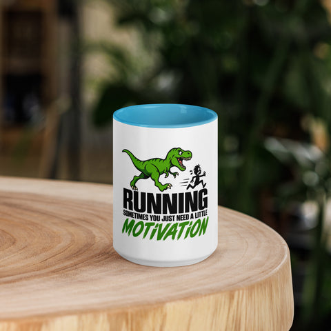 Front view of the 15 oz Dinosaur Motivation ceramic mug with blue interior and handle on a round wooden table with softly blurred greenery, showing its single front design.