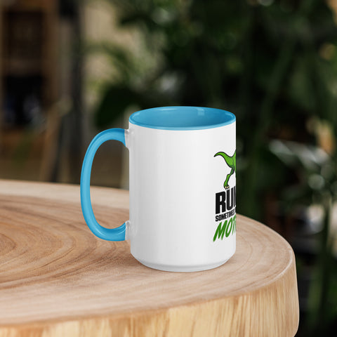 Left-side view of the 15 oz Dinosaur Motivation ceramic mug with blue interior and handle on a round wooden table with softly blurred greenery, showing its single front design.