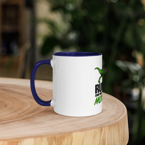 Left-side view of the 11 oz Dinosaur Motivation ceramic mug with dark blue interior and handle on a round wooden table with softly blurred greenery, showing its single front design.