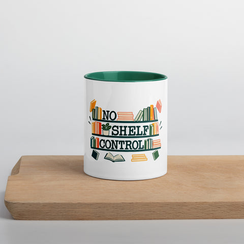 11 oz white No Shelf Control ceramic mug with dark green interior, rim and handle, front view on a wooden board; book illustration and green lettering printed once on the front.