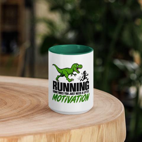 Front view of the 15 oz Dinosaur Motivation ceramic mug with dark green interior and handle on a round wooden table with softly blurred greenery, showing its single front design.