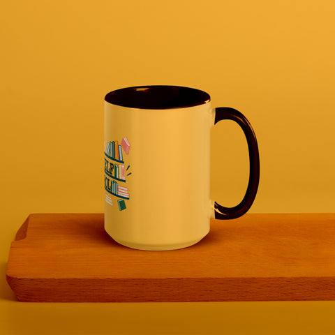 15 oz white No Shelf Control ceramic mug with golden yellow interior, rim and handle, right view on a wooden board; book illustration and green lettering printed once on the front.