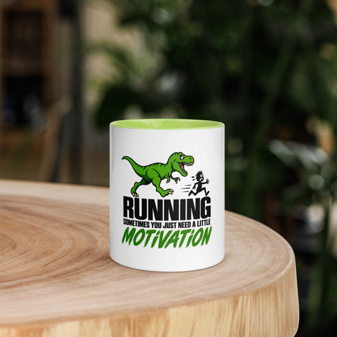 Front view of the 11 oz Dinosaur Motivation ceramic mug with green interior and handle on a round wooden table with softly blurred greenery, showing its single front design.