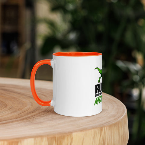 Left-side view of the 11 oz Dinosaur Motivation ceramic mug with orange interior and handle on a round wooden table with softly blurred greenery, showing its single front design.