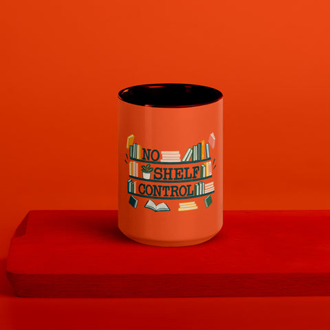 15 oz white No Shelf Control ceramic mug with orange interior, rim and handle, front view on a wooden board; book illustration and green lettering printed once on the front.