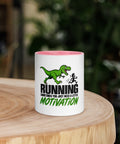 Front view of the 11 oz Dinosaur Motivation ceramic mug with pink interior and handle on a round wooden table with softly blurred greenery, showing its single front design.
