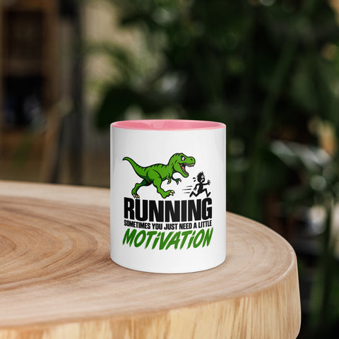 Front view of the 11 oz Dinosaur Motivation ceramic mug with pink interior and handle on a round wooden table with softly blurred greenery, showing its single front design.