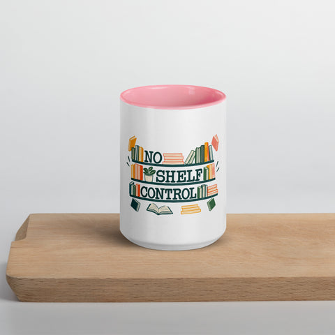 15 oz white No Shelf Control ceramic mug with pink interior, rim and handle, front view on a wooden board; book illustration and green lettering printed once on the front.