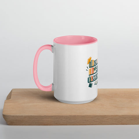 15 oz white No Shelf Control ceramic mug with pink interior, rim and handle, left view on a wooden board; book illustration and green lettering printed once on the front.