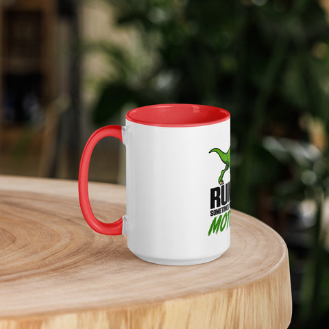 Left-side view of the 15 oz Dinosaur Motivation ceramic mug with red interior and handle on a round wooden table with softly blurred greenery, showing its single front design.