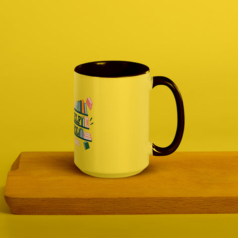 15 oz white No Shelf Control ceramic mug with yellow interior, rim and handle, right view on a wooden board; book illustration and green lettering printed once on the front.