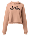 Stay Curious women’s Peach cropped hoodie, front with complete black typography and magnifying glass graphic