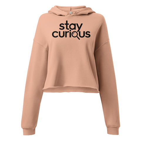 Stay Curious women’s Peach cropped hoodie, front with complete black typography and magnifying glass graphic