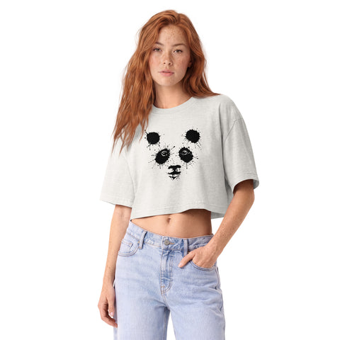 Model wearing the Vintage White Ink Splatter Panda women’s garment-dyed cropped tee with light denim jeans, showing its single black panda front print and oversized sleeves.