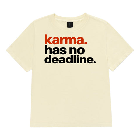 Karma Has No Deadline women's heavyweight garment-dyed tee in Buttermilk – front with rust-orange and black lettering, product view 2