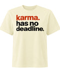 Karma Has No Deadline women's heavyweight garment-dyed tee in Buttermilk – front with rust-orange and black lettering, product view 1