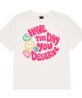 Vintage White women's heavyweight garment-dyed tee, front view with pink Have the Day You Deserve lettering and colourful smiley faces.