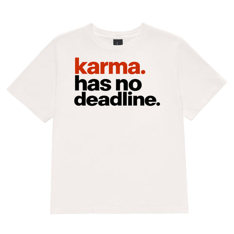 Karma Has No Deadline women's heavyweight garment-dyed tee in Vintage White – front with rust-orange and black lettering, product view 2