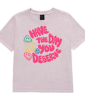 Washed Lavender women's heavyweight garment-dyed tee, front view with pink Have the Day You Deserve lettering and colourful smiley faces.
