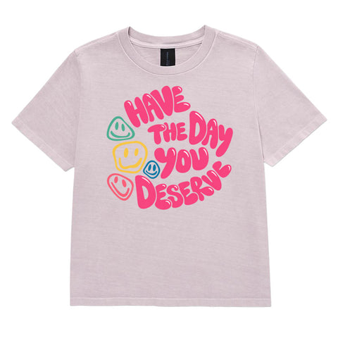 Washed Lavender women's heavyweight garment-dyed tee, front view with pink Have the Day You Deserve lettering and colourful smiley faces.
