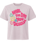 Washed Lavender women's heavyweight garment-dyed tee, front view with pink Have the Day You Deserve lettering and colourful smiley faces.