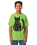 Youth model wearing a Lime One Cat Away youth classic tee, showing the black cat-shaped One Cat Away From Crazy print on the front.