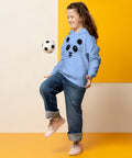 Carolina Blue youth hoodie worn by a child playing with a football, with the original black ink-splatter panda face on the front.