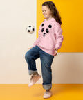 Light Pink youth hoodie worn by a child playing with a football, with the original black ink-splatter panda face on the front.