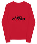 Red Stay Curious youth long-sleeve tee with one black magnifying-glass lettering design on the front.