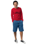 Red Stay Curious youth long-sleeve tee worn by a model, showing one black front print and plain sleeves.