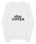 White Stay Curious youth long-sleeve tee with one black magnifying-glass lettering design on the front.