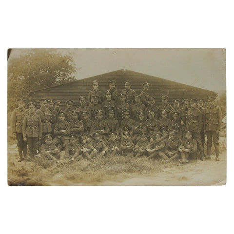 British Soldiers Photo in front of a wooden barracks, World War I Era Postcard