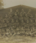 British Soldiers Photo in front of a wooden barracks, World War I Era Postcard